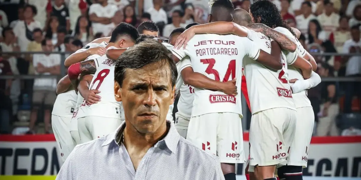 Fabián Bustos mirando algo molesto y el equipo de Universitario abrazándose