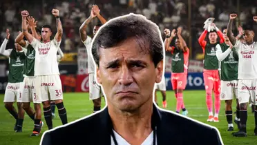 Fabián Bustos mirando con cara seria y los jugadores de Universitario saludando a la tribuna